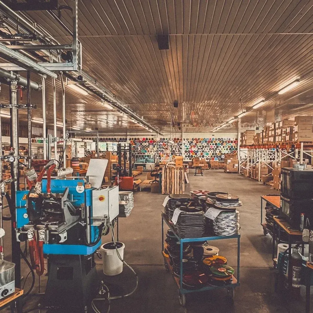 Vinyl record being pressed in a production machine