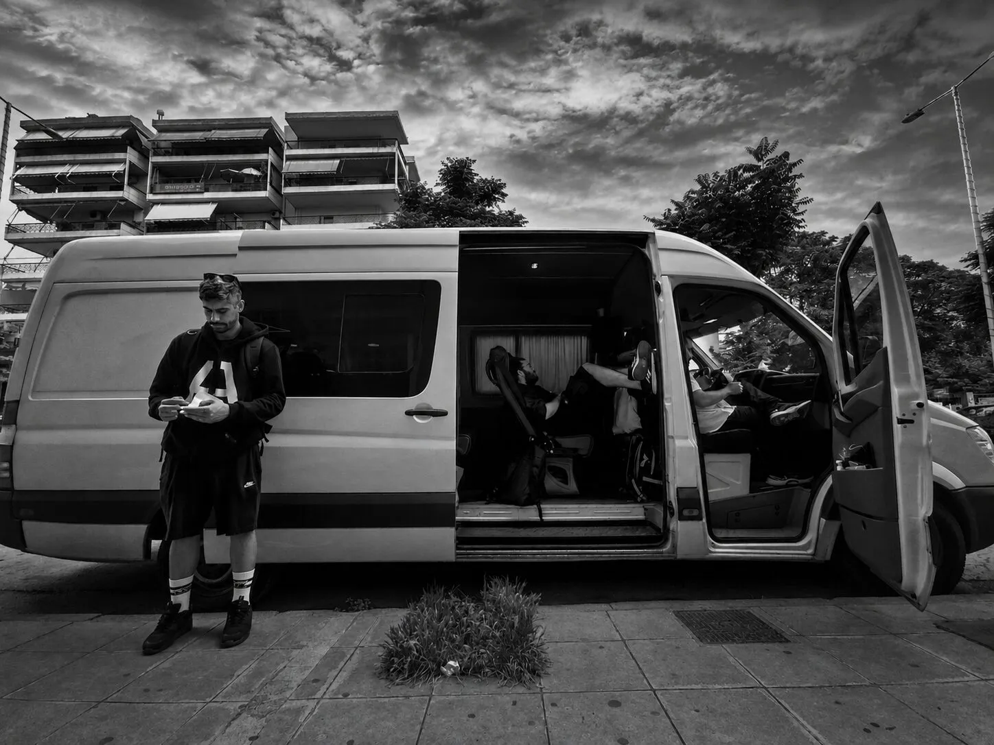 Band members taking a break beside their tour van